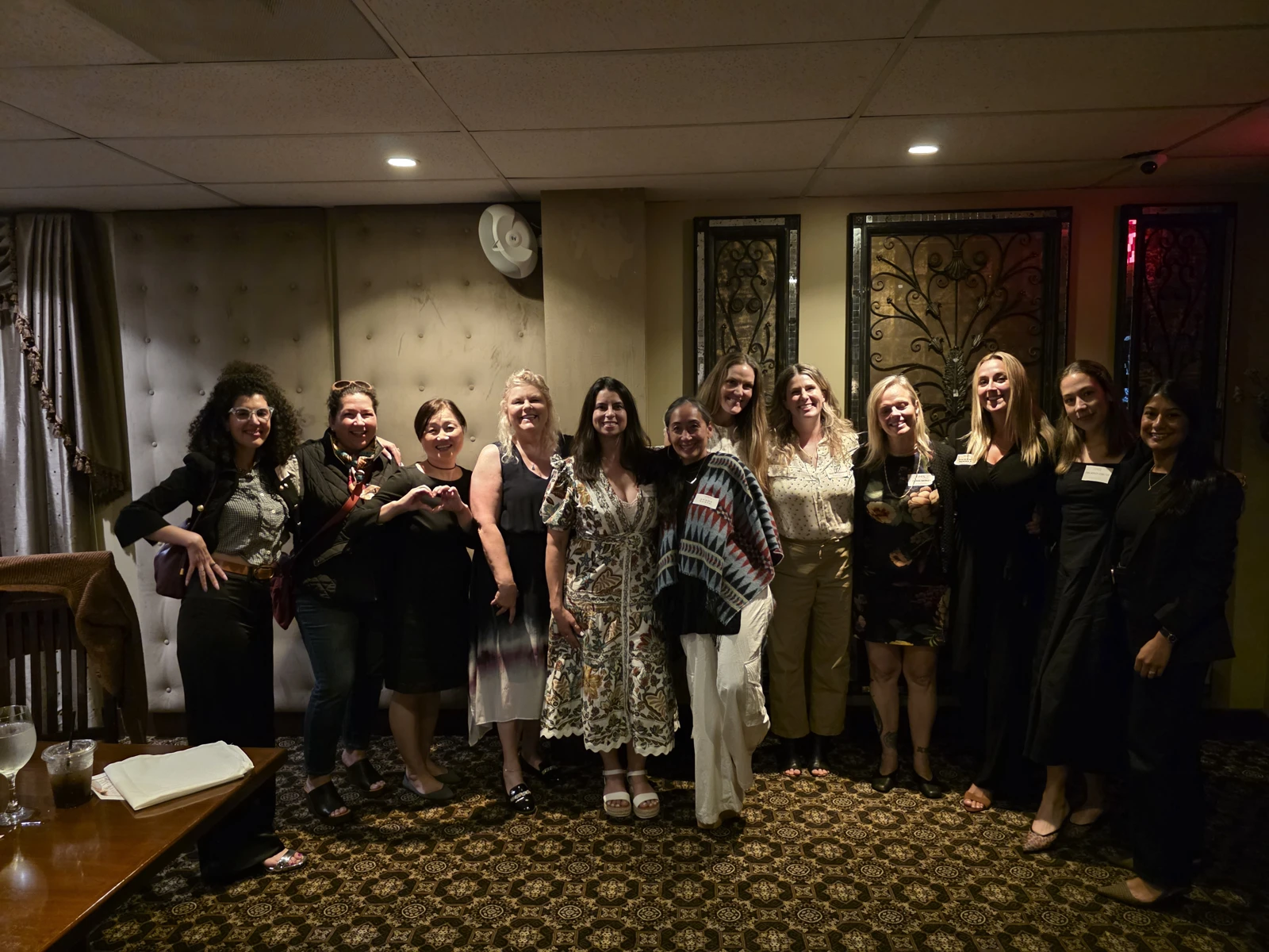 Women standing together at a FoundHER and FundHER dinner