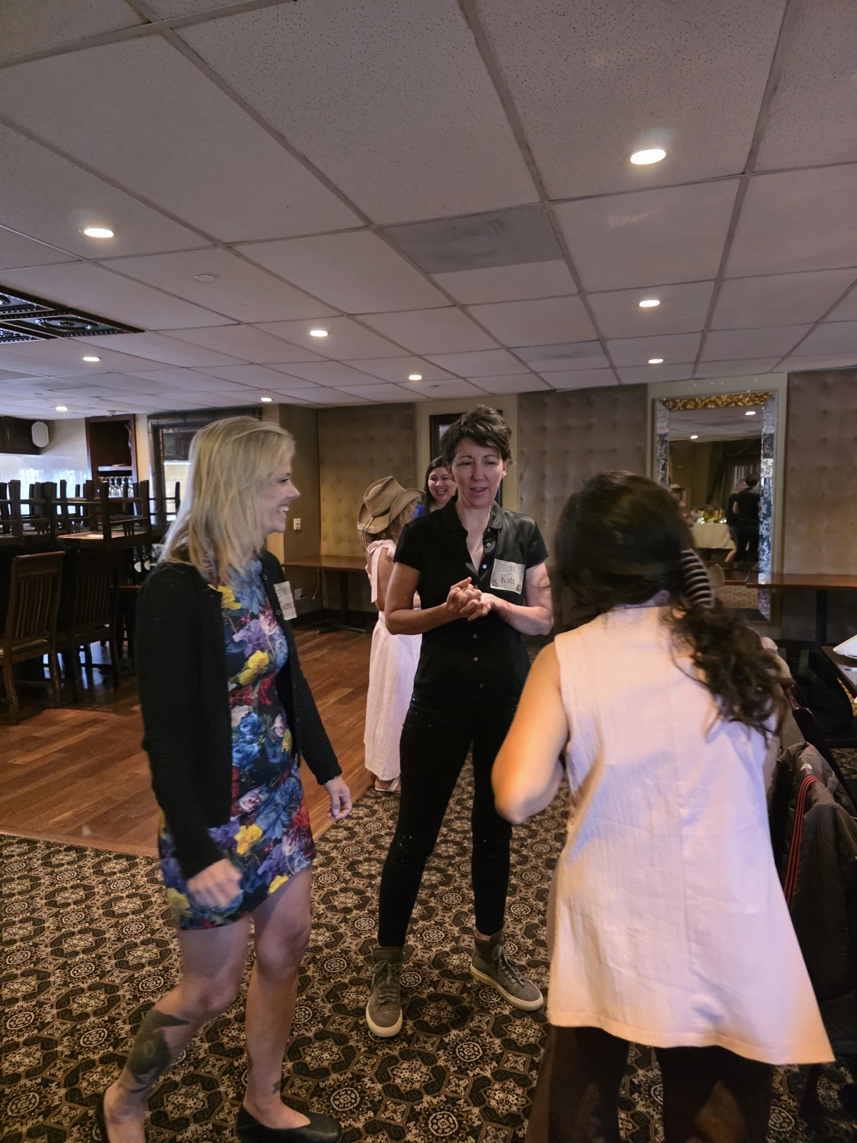 Women sharing a conversation at a community dinner